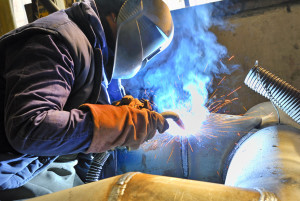 Man welding an electrical enclosure in Dallas.
